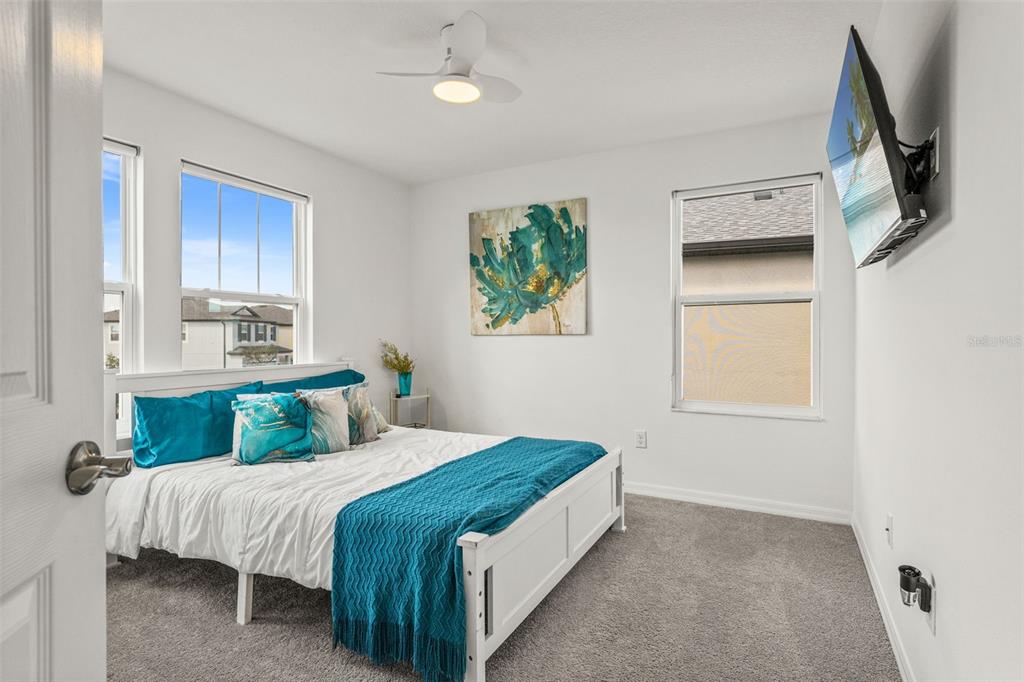 5945 Newberry Pnes Avenue Wesley Chapel, FL 33545 - Photo 41 of 55 a bedroom with a bed and a window