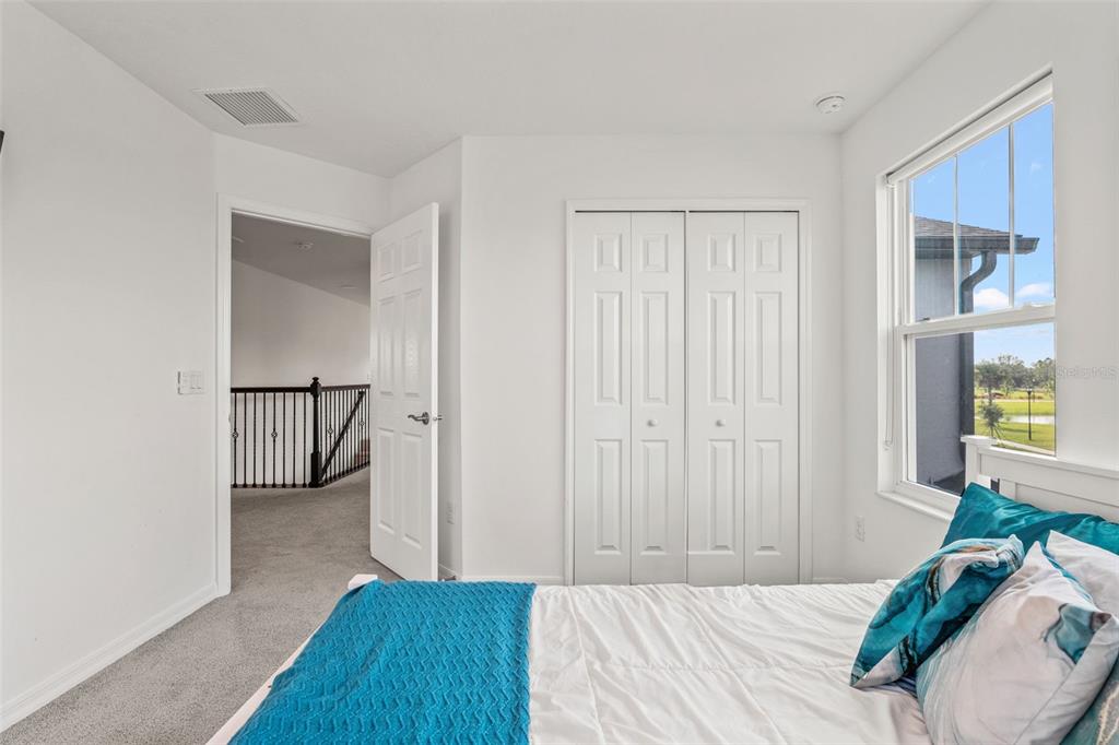 5945 Newberry Pnes Avenue Wesley Chapel, FL 33545 - Photo 42 of 55 a bedroom with a bed and a window