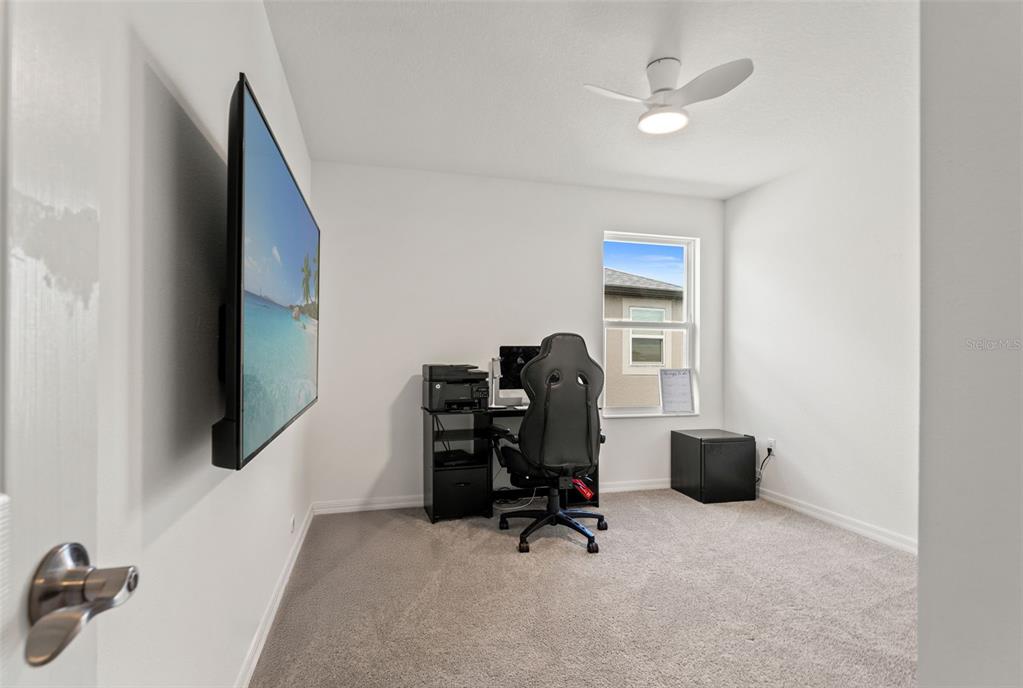 5945 Newberry Pnes Avenue Wesley Chapel, FL 33545 - Photo 44 of 55 a view of a workspace with furniture and a window