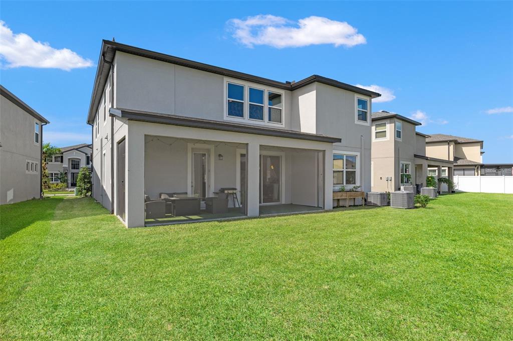 5945 Newberry Pnes Avenue Wesley Chapel, FL 33545 - Photo 49 of 55 a view of a house with a yard and pathway