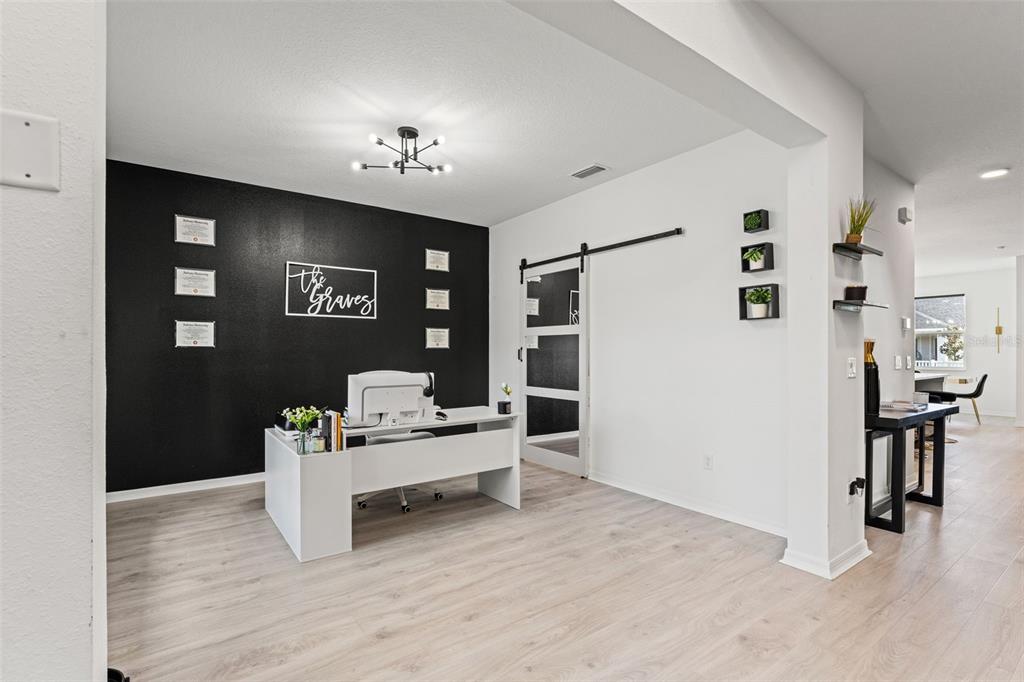 5945 Newberry Pnes Avenue Wesley Chapel, FL 33545 - Photo 5 of 55 a view of a hallway with dining room and wooden floor