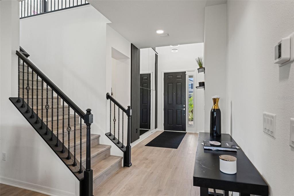 5945 Newberry Pnes Avenue Wesley Chapel, FL 33545 - Photo 9 of 55 a view of a hallway with staircase