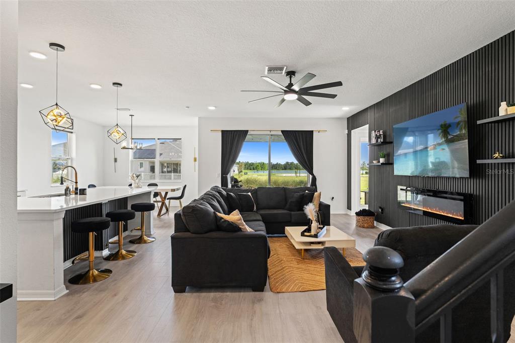 5945 Newberry Pnes Avenue Wesley Chapel, FL 33545 - Photo 10 of 55 a living room with furniture and a flat screen tv
