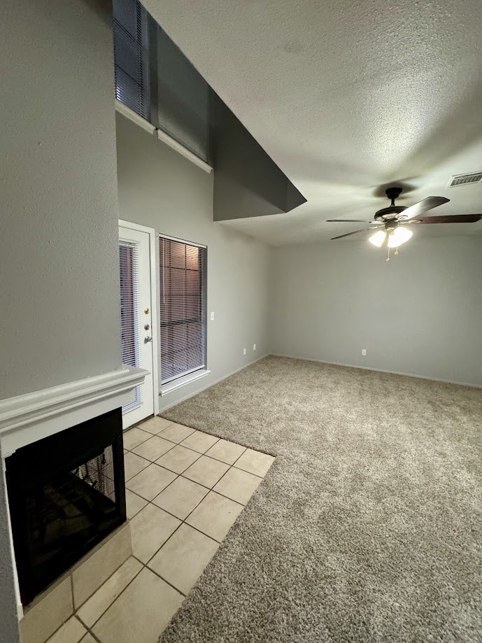 1305 West Villa Maria Road, Unit C107 Bryan, TX 77801 - Photo 4 of 19 a view of an empty room with a fireplace