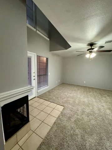 a view of an empty room with a fireplace