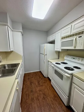 a kitchen with a stove and a refrigerator
