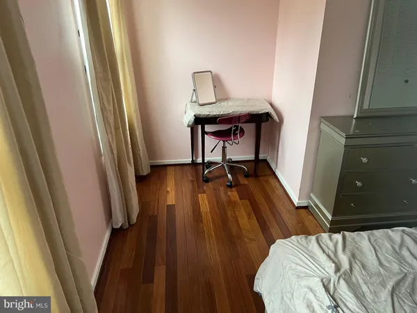 a bedroom with a bed and a mirror