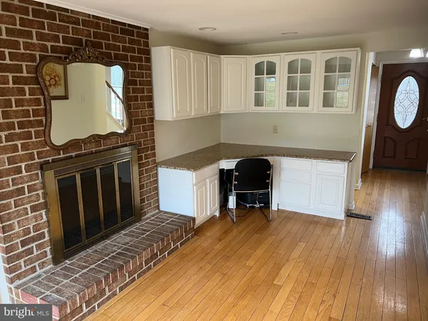 a view of a livingroom with wooden floor and furniture