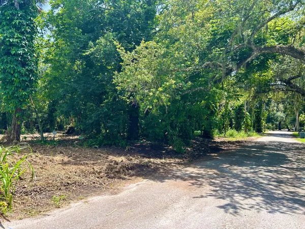 an aerial view of a residential houses with outdoor space and lake view