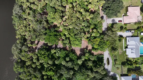 an aerial view of a houses with a yard