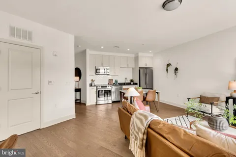 a living room with lots of furniture and white appliances