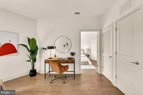 a living room with furniture flowers and a potted plant