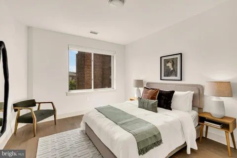 a bedroom with a bed a lamp and a window