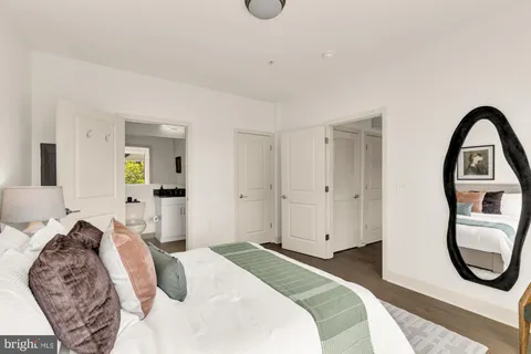 a bedroom with a bed and a mirror