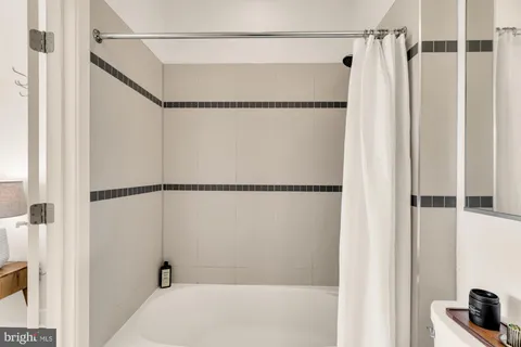 a bathroom with a shower and a tub