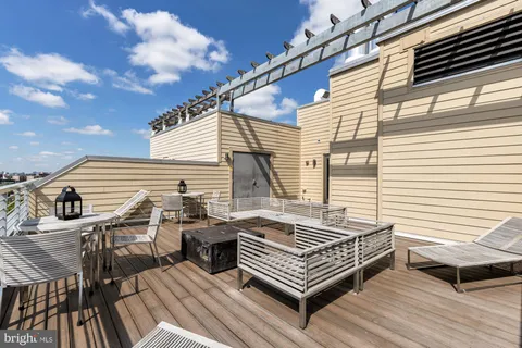 a view of a roof deck with wooden floor and fence