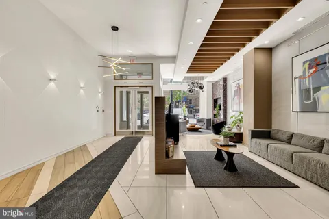 a lobby with furniture and rug