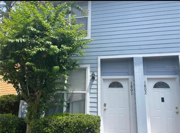 front view of a house with a tree