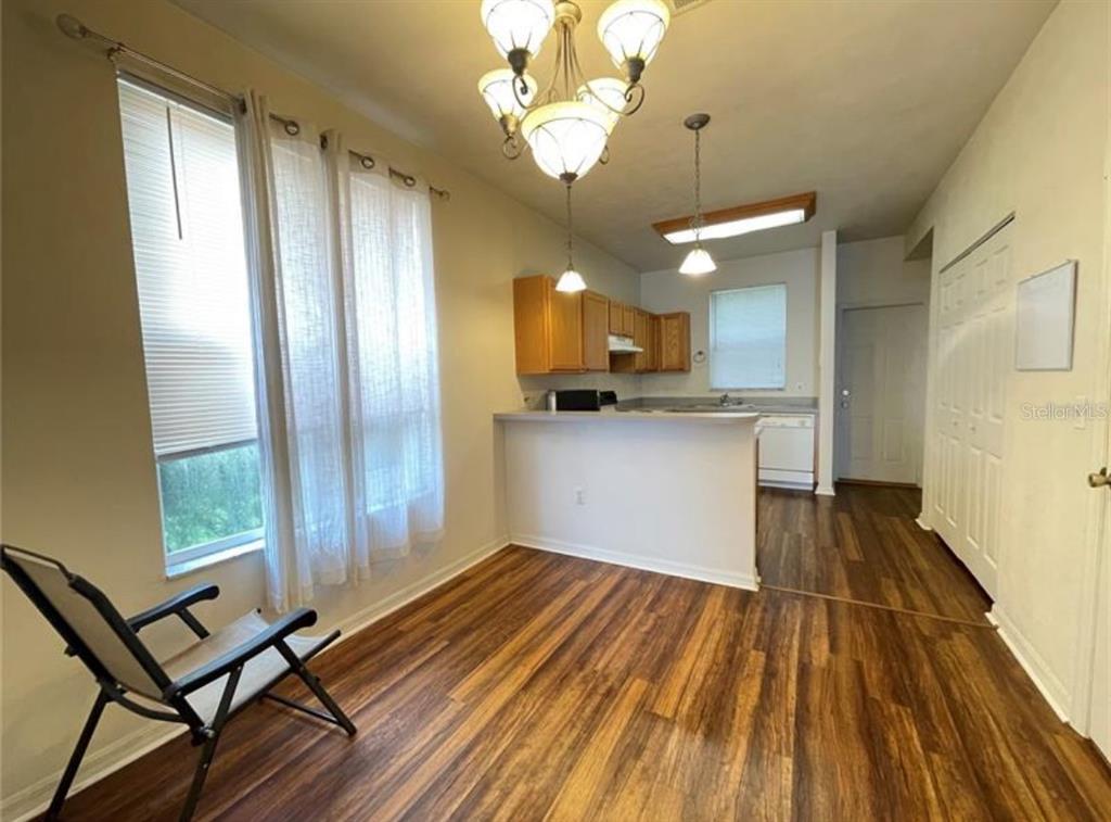 3860 Southwest 20th Avenue, Unit 1801 Gainesville, FL 32607 - Photo 2 of 19 a view of a kitchen with wooden floor and a window
