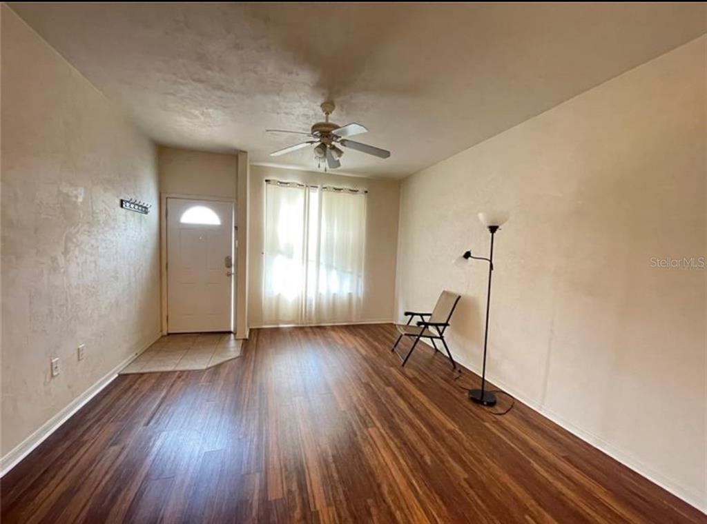 3860 Southwest 20th Avenue, Unit 1801 Gainesville, FL 32607 - Photo 3 of 19 wooden floor in an empty room with a window