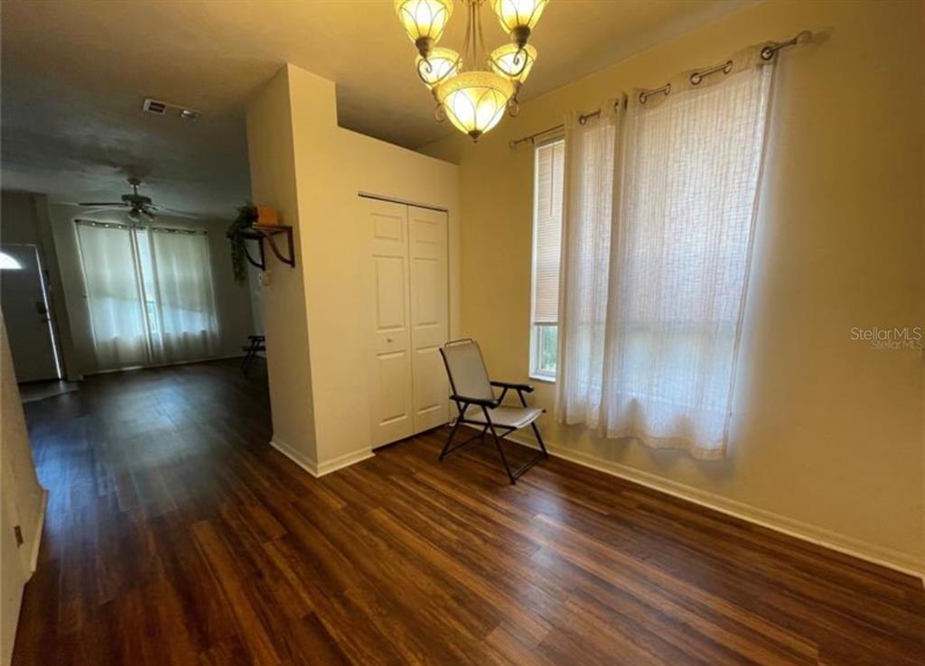 3860 Southwest 20th Avenue, Unit 1801 Gainesville, FL 32607 - Photo 8 of 19 a view of a room with wooden floor mirror and windows