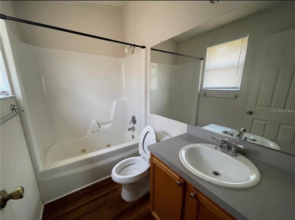 3860 Southwest 20th Avenue, Unit 1801 Gainesville, FL 32607 - Photo 10 of 19 a bathroom with a sink a toilet and shower