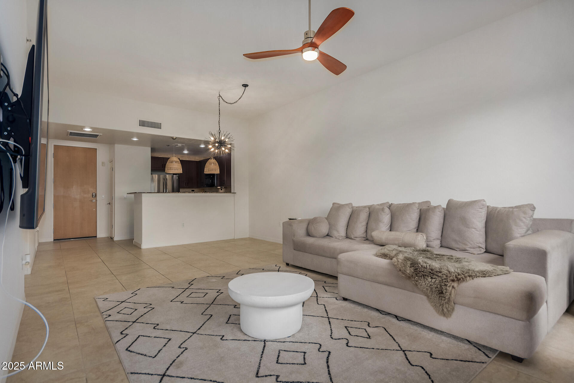 2302 North Central Avenue, Unit 206 Phoenix, AZ 85004 - Photo 11 of 35 a living room with furniture and a dining table with white walls