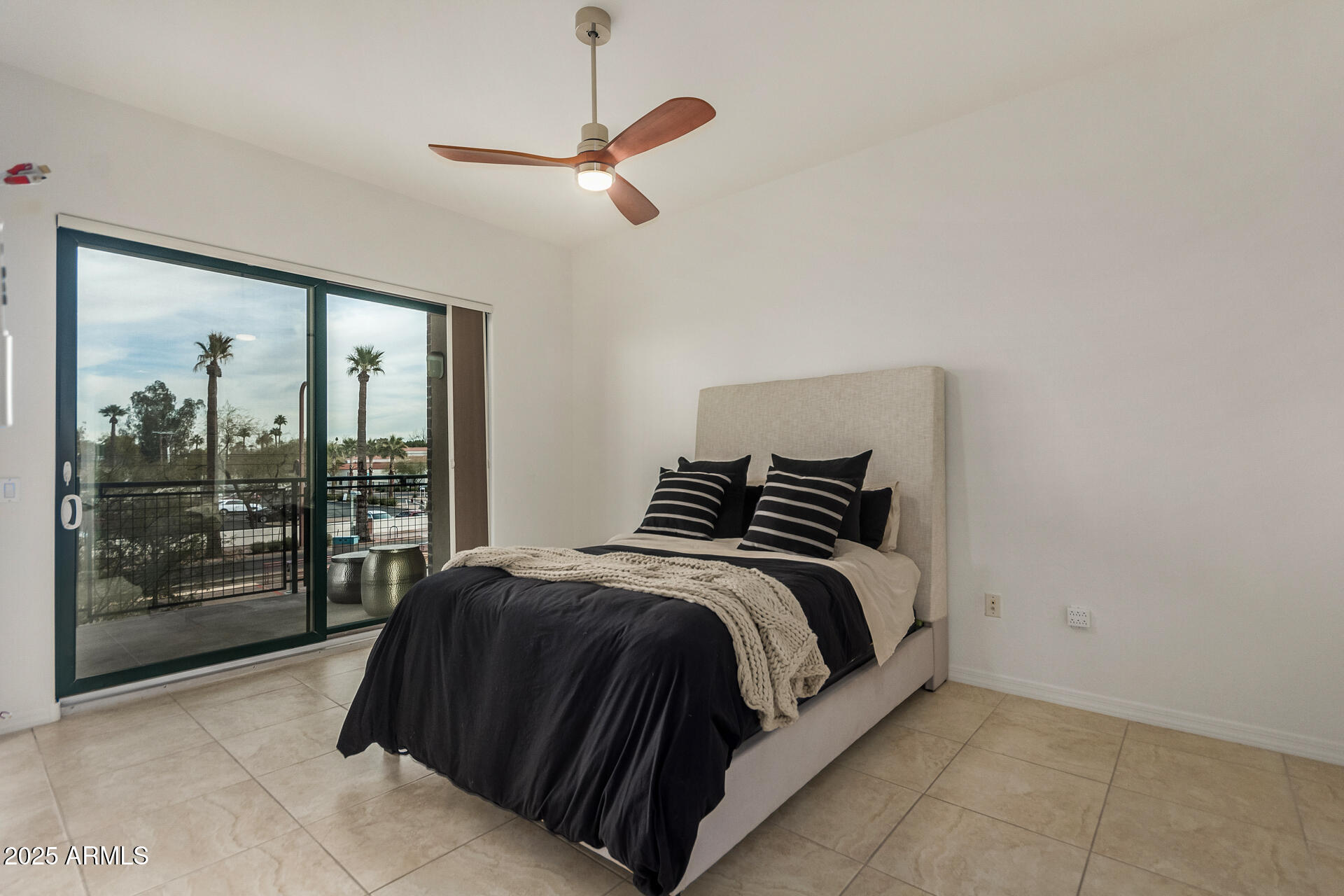 2302 North Central Avenue, Unit 206 Phoenix, AZ 85004 - Photo 13 of 35 a spacious bedroom with a bed and glass door