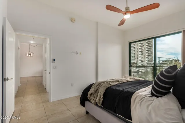 a bedroom with a bed and next to a window