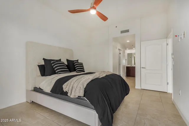 a bedroom with a bed and ceiling fan