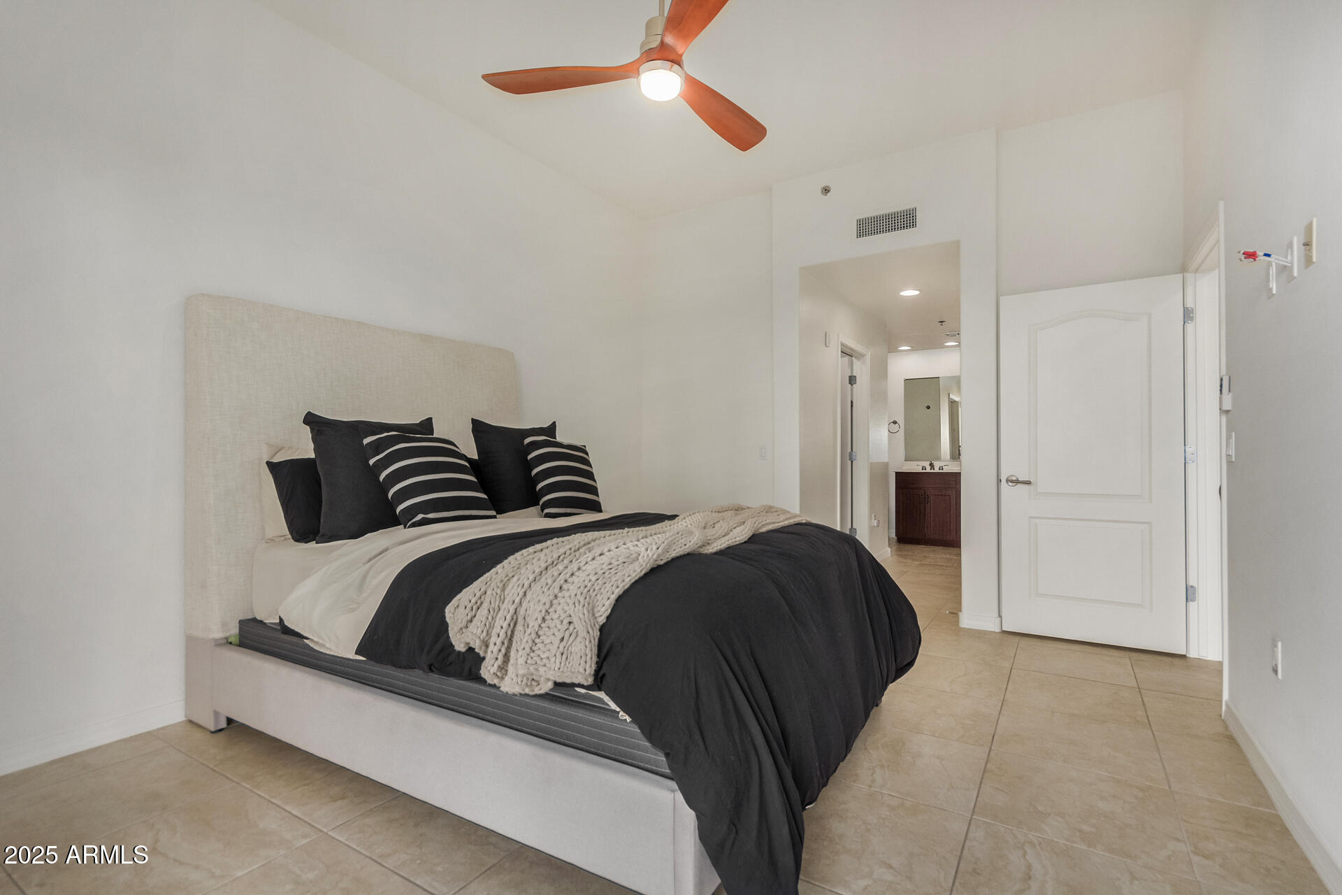 2302 North Central Avenue, Unit 206 Phoenix, AZ 85004 - Photo 15 of 35 a bedroom with a bed and ceiling fan