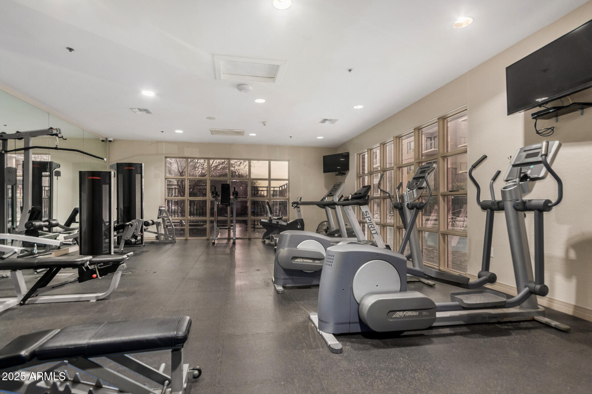 2302 North Central Avenue, Unit 206 Phoenix, AZ 85004 - Photo 29 of 35 a room with gym equipment and large mirror