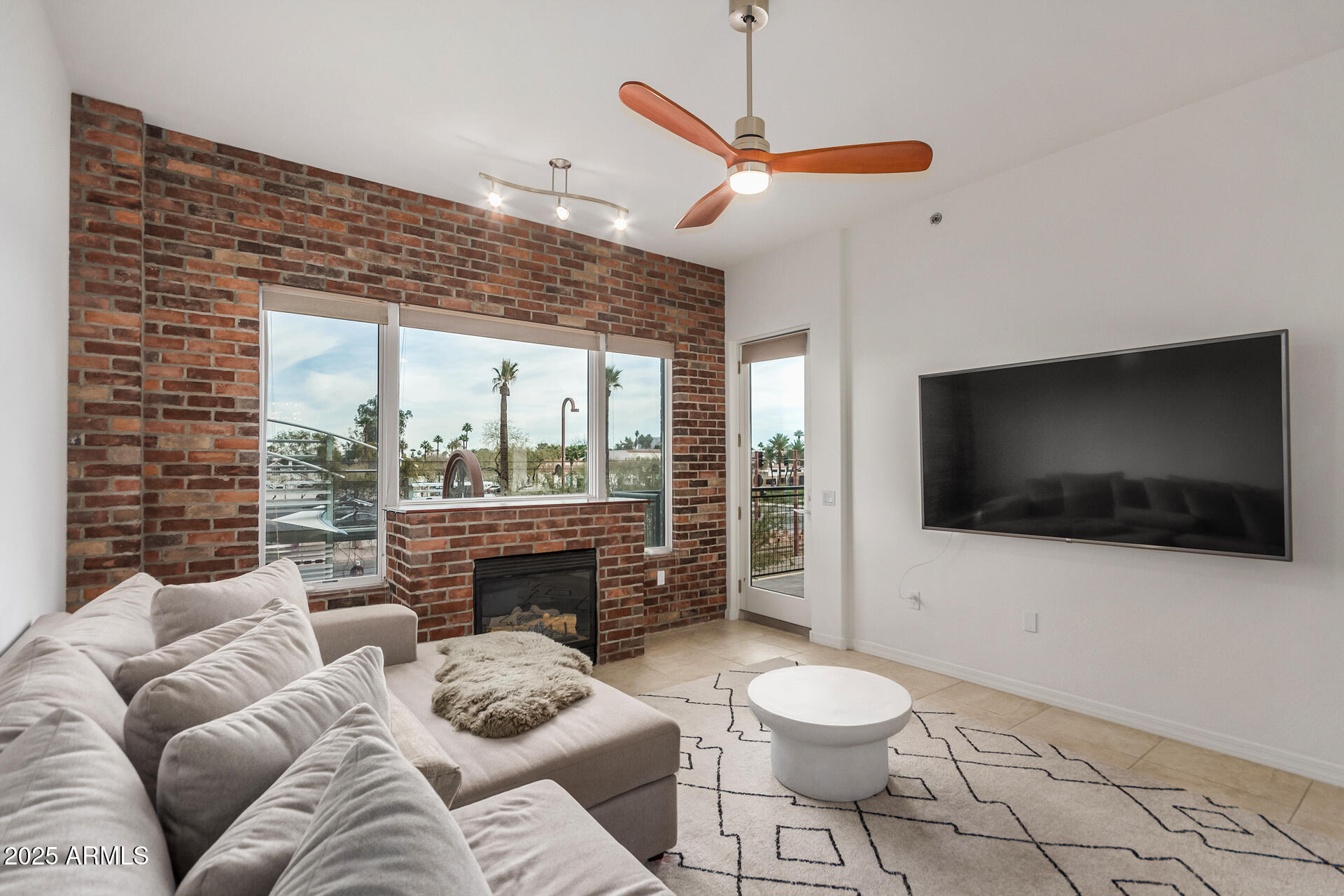 2302 North Central Avenue, Unit 206 Phoenix, AZ 85004 - Photo 3 of 35 a living room with furniture a flat screen tv and a floor to ceiling window
