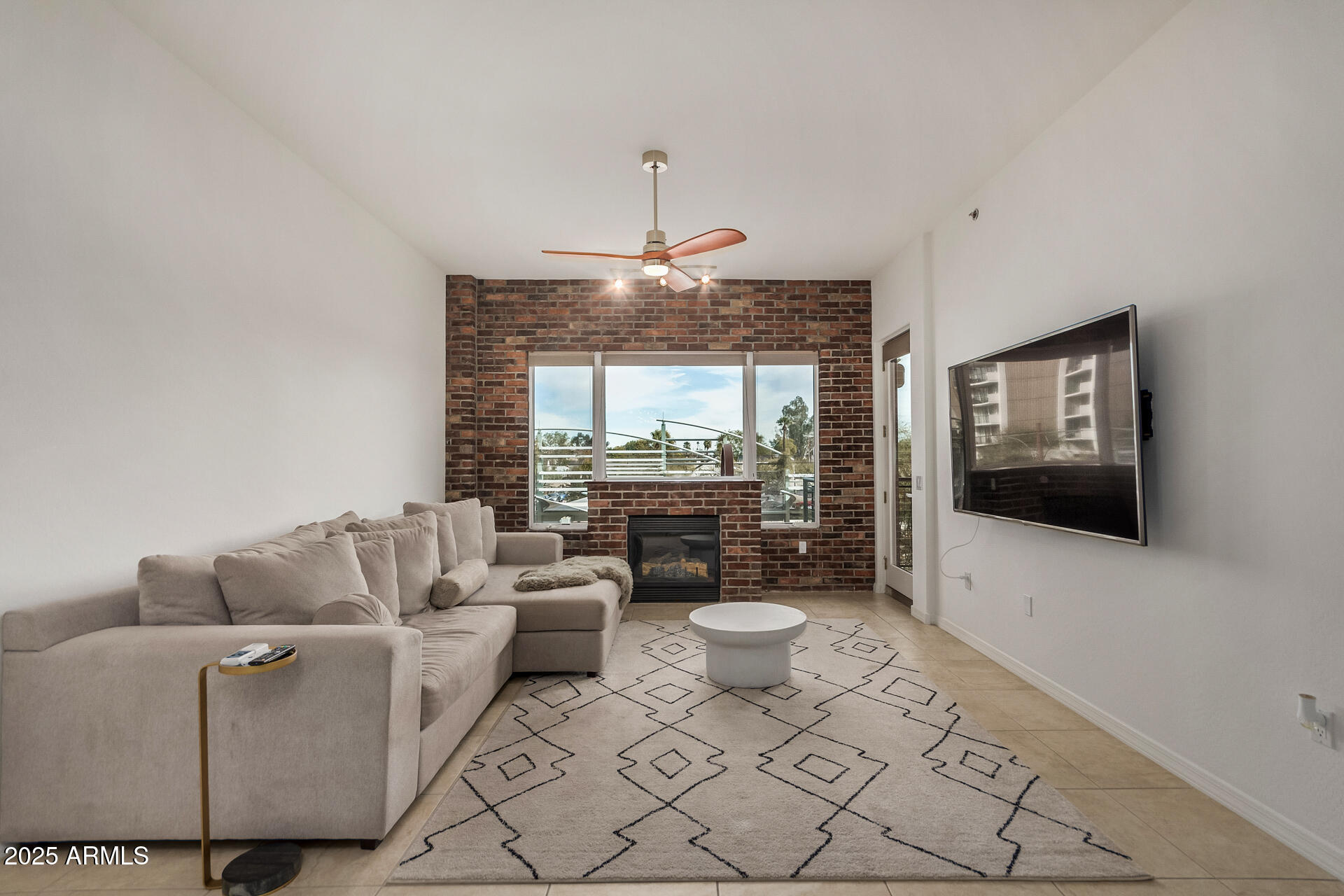 2302 North Central Avenue, Unit 206 Phoenix, AZ 85004 - Photo 4 of 35 a living room with furniture a flat screen tv and a chandelier