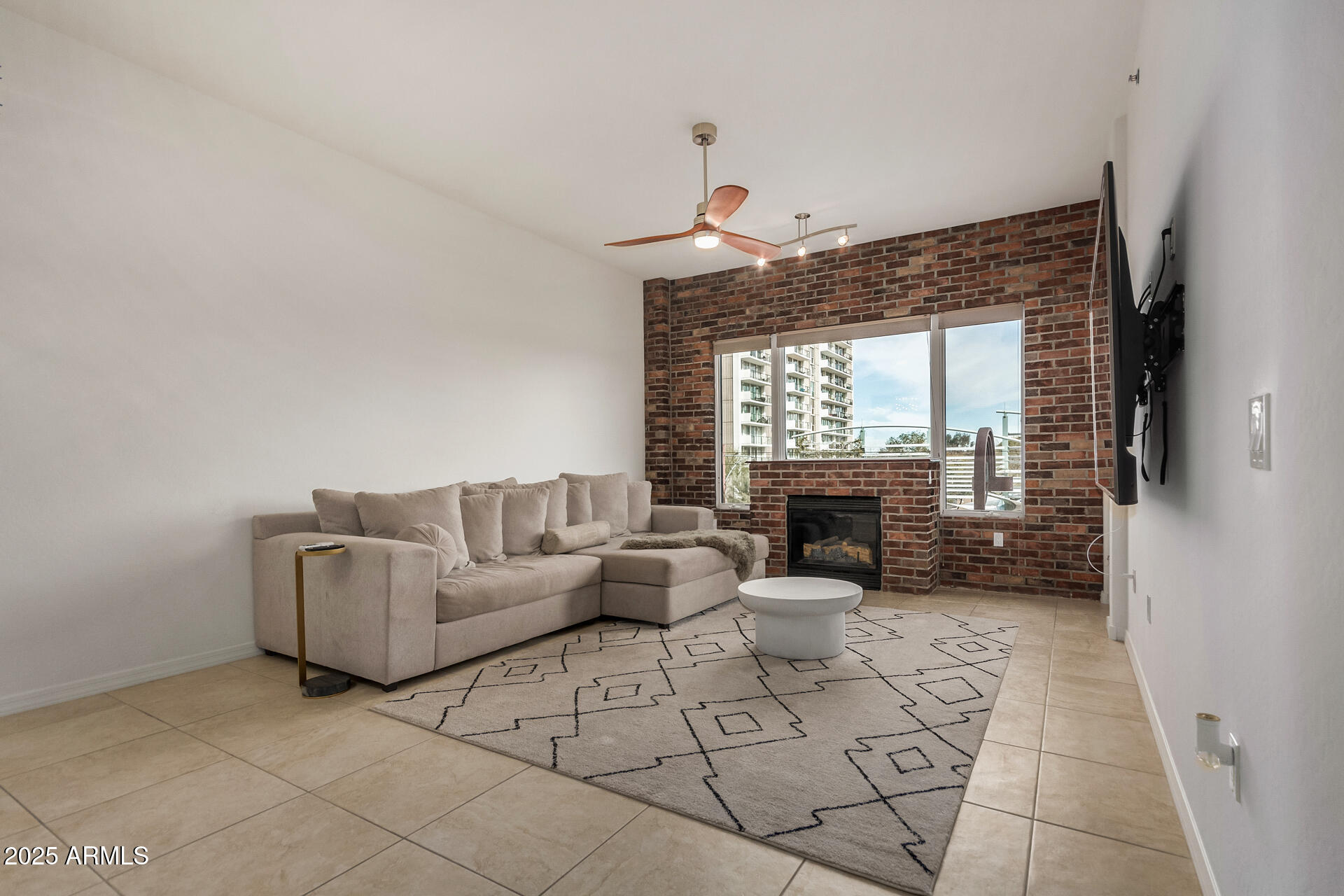 2302 North Central Avenue, Unit 206 Phoenix, AZ 85004 - Photo 6 of 35 a living room with furniture a fireplace and a floor to ceiling window