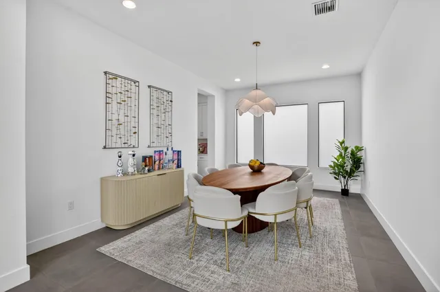a living room with furniture lamp and a potted plant