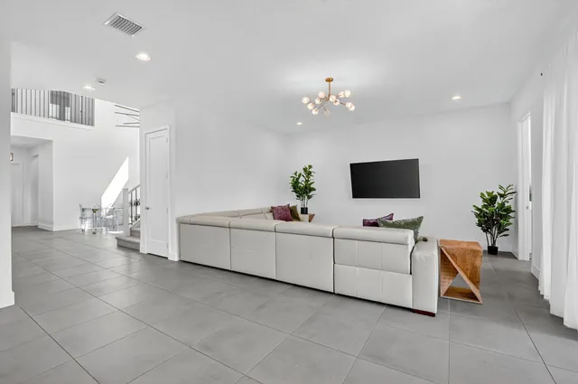 a kitchen with white cabinets and a stove with a sink