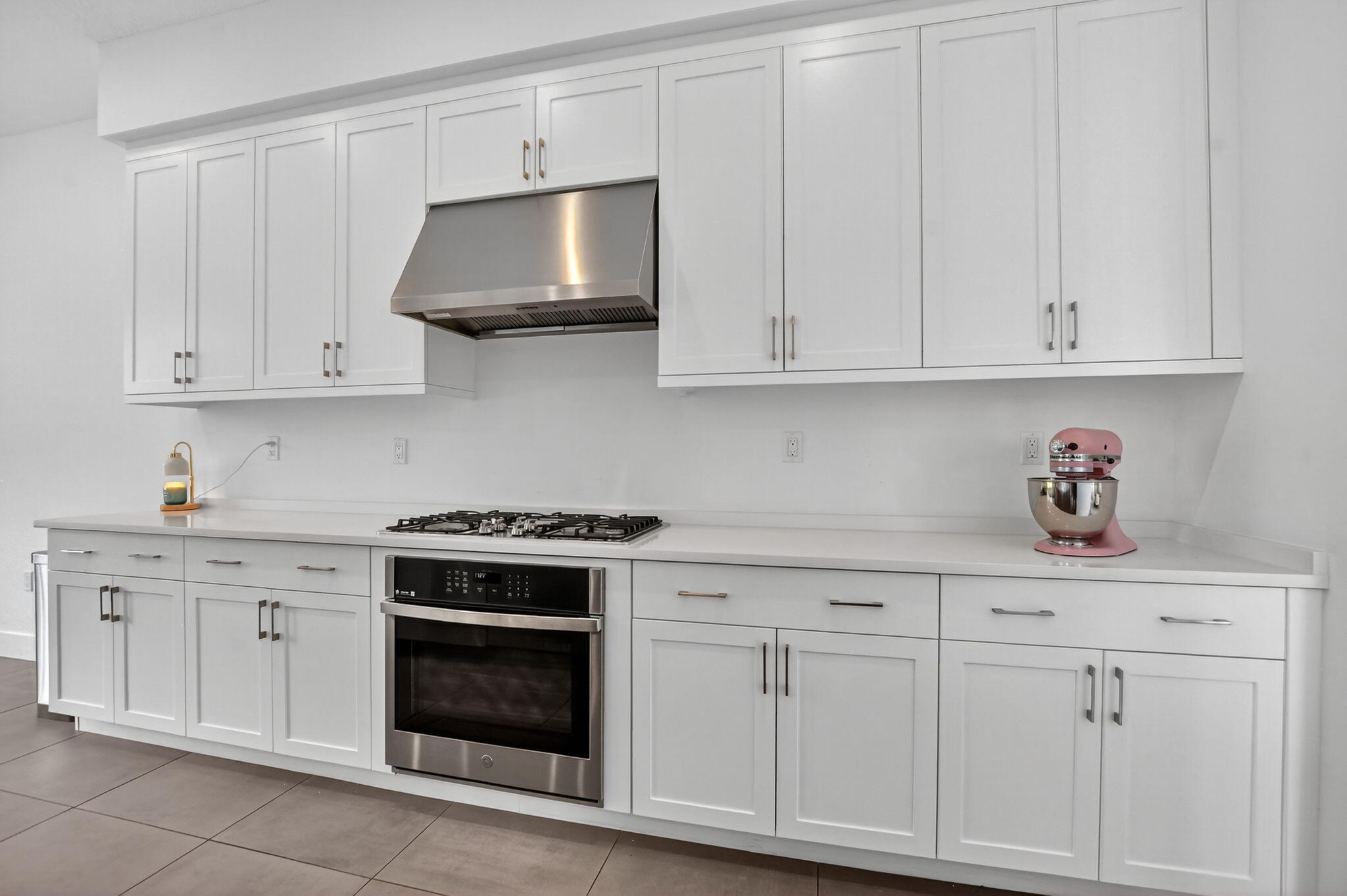 8284 Royal County Down Road Boca Raton, FL 33434 - Photo 26 of 121 a kitchen with white cabinets and a stove with a sink