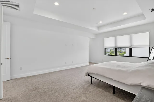 a view of a street with a cars park palm trees