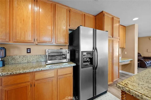 a kitchen with stainless steel appliances granite countertop a sink a stove and a microwave