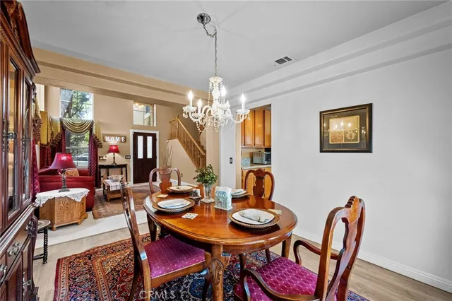 a kitchen with stainless steel appliances granite countertop a sink and cabinets with wooden floor