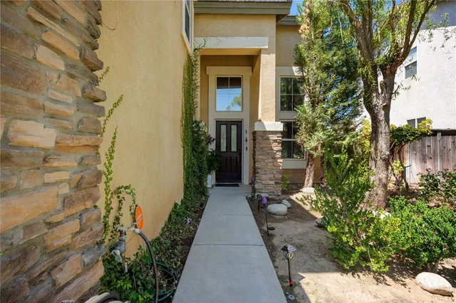 a living room with furniture a flat screen tv and a wall painting