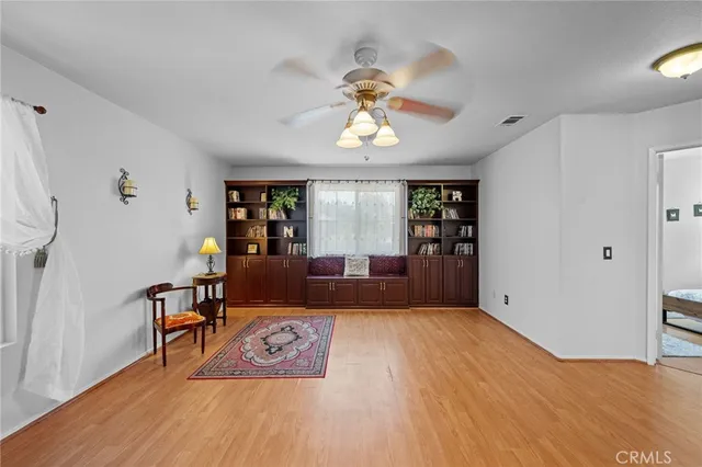a spacious bedroom with a bed a chandelier and a window