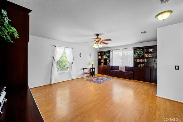 a view of balcony with wooden floor and seating space