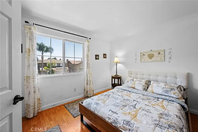 a backyard of a house with table and chairs a barbeque with potted plants