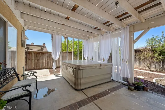 a white house with a large tree in front of it