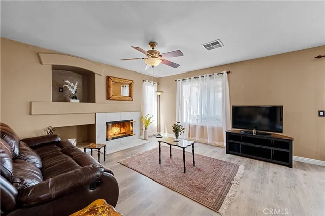 a living room with furniture a fireplace and a table