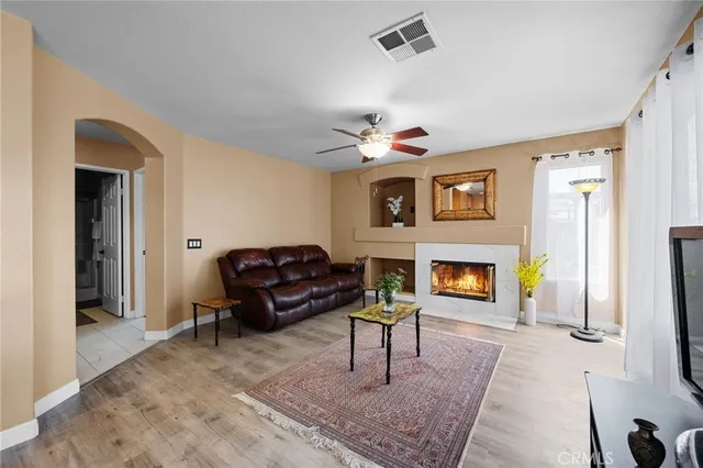 a kitchen with stainless steel appliances granite countertop a refrigerator a sink and white cabinets