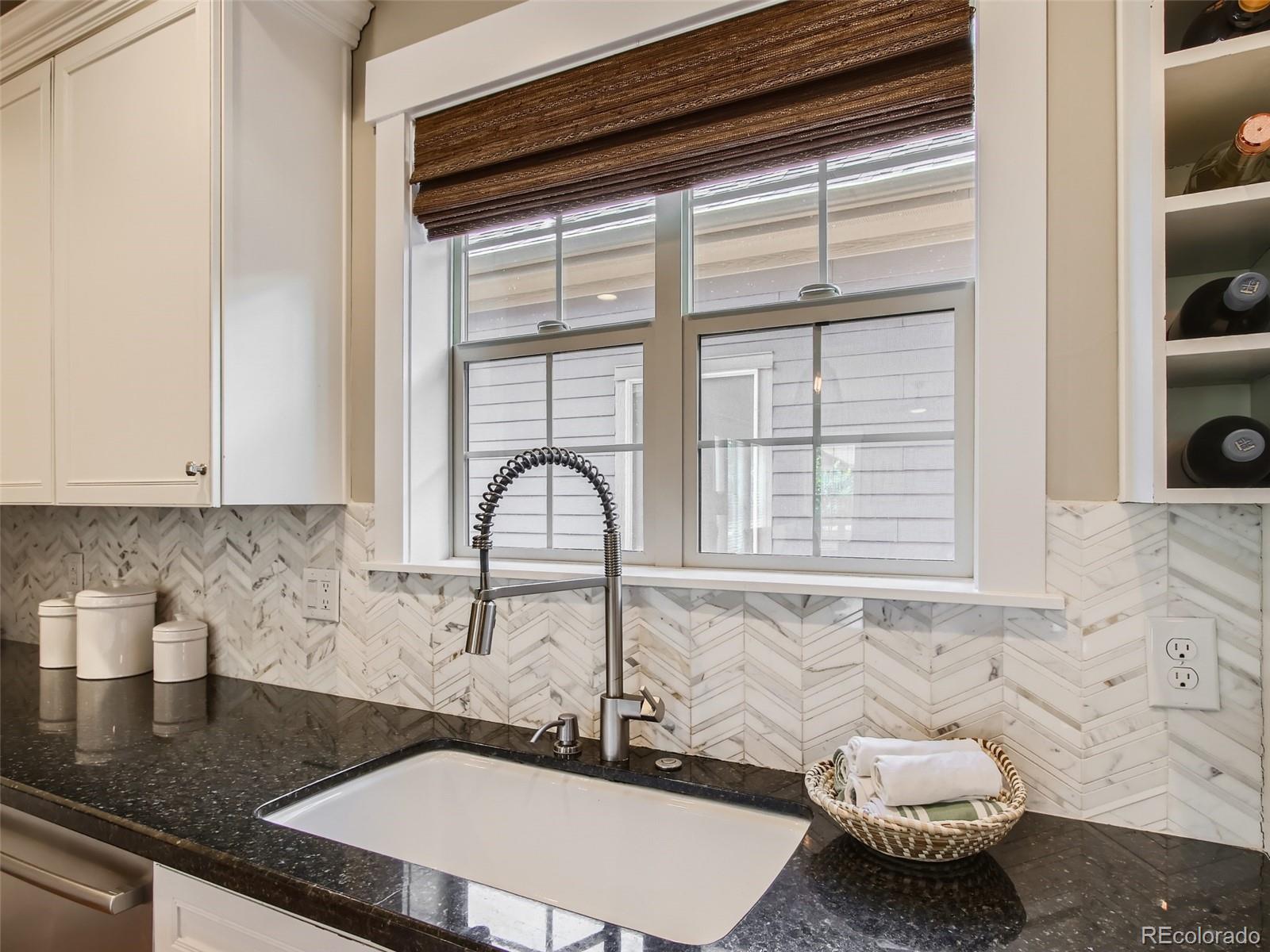 303 Alton Way Denver, CO 80230 - Photo 11 of 35 a kitchen with a sink and a window