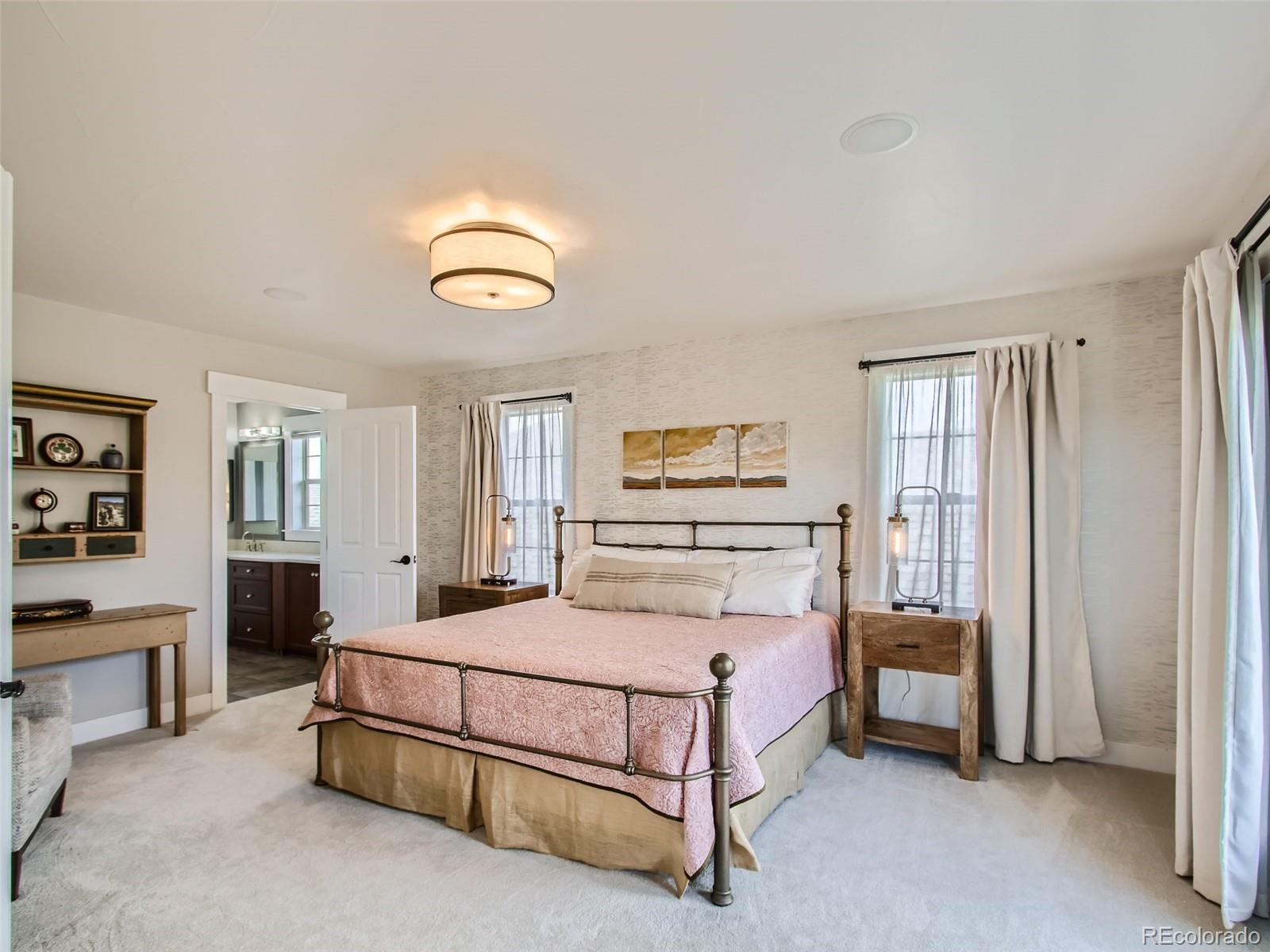 303 Alton Way Denver, CO 80230 - Photo 13 of 35 a bedroom with a bed and a cabinets